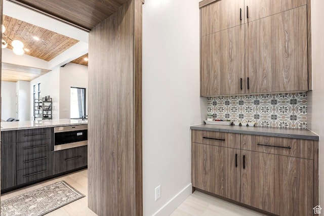 9335 N Canopy Ln E, Sundance, UT 84604 - bar with wooden ceiling, decorative backsplash, baseboards, and light wood finished floors
