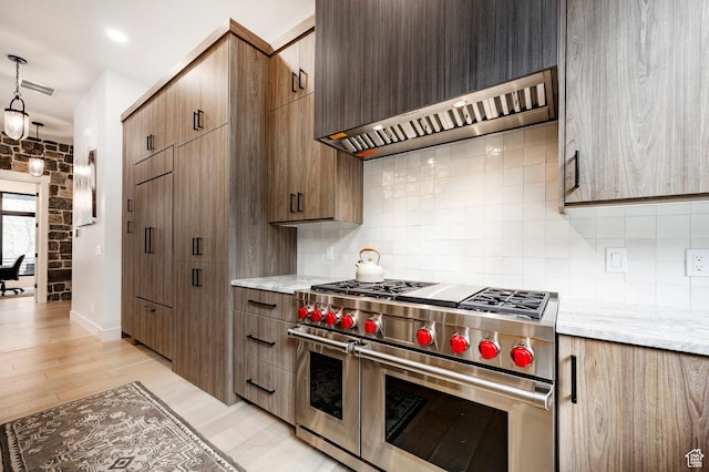 9335 N Canopy Ln E, Sundance, UT 84604 - kitchen with double oven range, wall chimney exhaust hood, tasteful backsplash, and light wood-type flooring