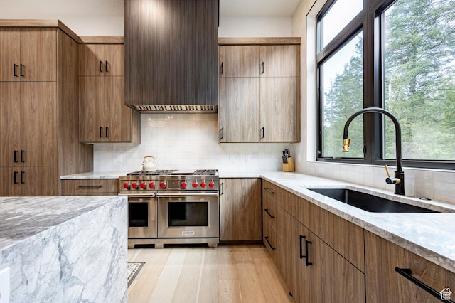 9335 N Canopy Ln E, Sundance, UT 84604 - kitchen with double oven range, a sink, custom exhaust hood, light stone counters, and backsplash