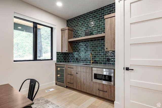 9335 N Canopy Ln E, Sundance, UT 84604 - kitchen featuring beverage cooler, a sink, open shelves, decorative backsplash, and recessed lighting