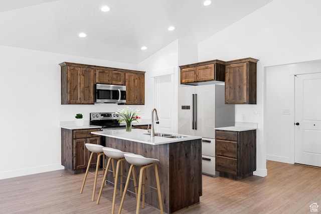 309 N 2350 E Unit 01, Spanish Fork, UT 84660 - kitchen featuring stainless steel appliances, light wood finished floors, vaulted ceiling, a breakfast bar, and light countertops