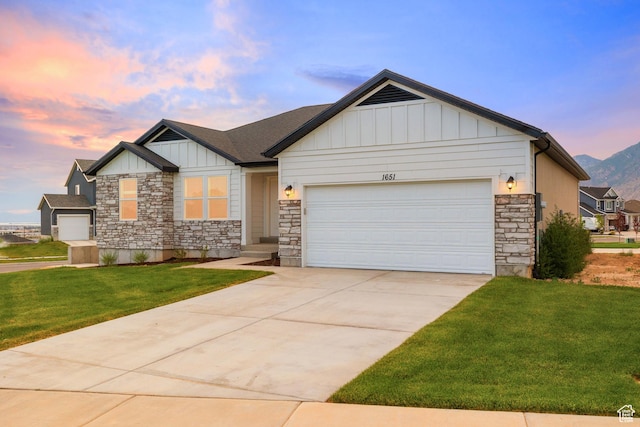 309 N 2350 E Unit 01, Spanish Fork, UT 84660 - craftsman-style house featuring stone siding, a garage, board and batten siding, a front lawn, and concrete driveway