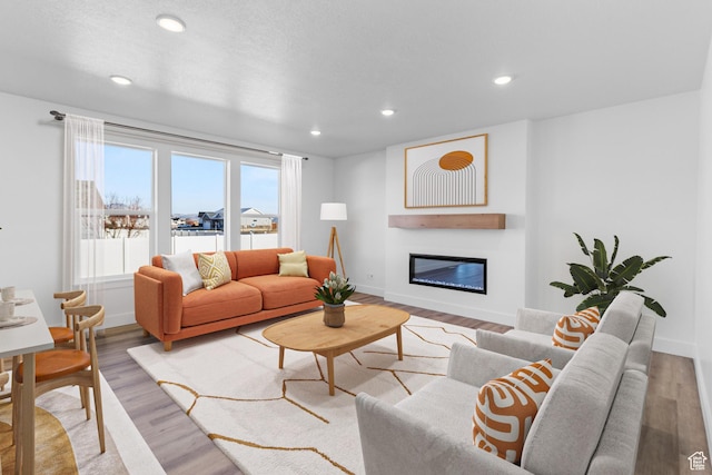 101 N 950 E Unit 36, Tremonton, UT 84337 - living room with a glass covered fireplace, light wood-type flooring, baseboards, and recessed lighting
