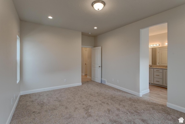 2318 E 320 N Unit 01, Spanish Fork, UT 84660 - unfurnished bedroom featuring light colored carpet, recessed lighting, and connected bathroom