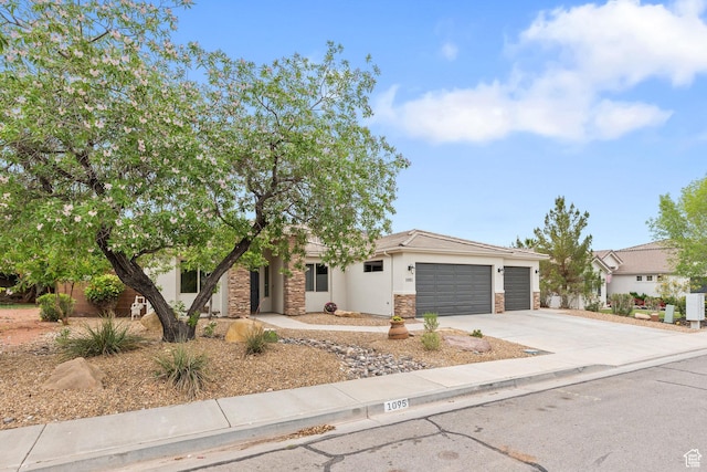 1095 S White Sands Dr, Washington, UT 84780 - view of front of house with stone siding, concrete driveway, a garage, and stucco siding