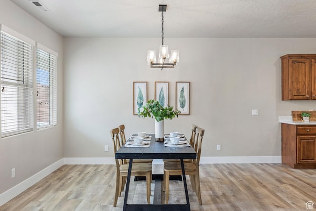 1095 S White Sands Dr, Washington, UT 84780 - dining room with healthy amount of natural light, light wood finished floors, a chandelier, and baseboards