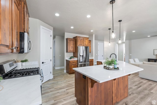 1095 S White Sands Dr, Washington, UT 84780 - kitchen featuring stainless steel appliances, open floor plan, brown cabinetry, light wood-style floors, and recessed lighting