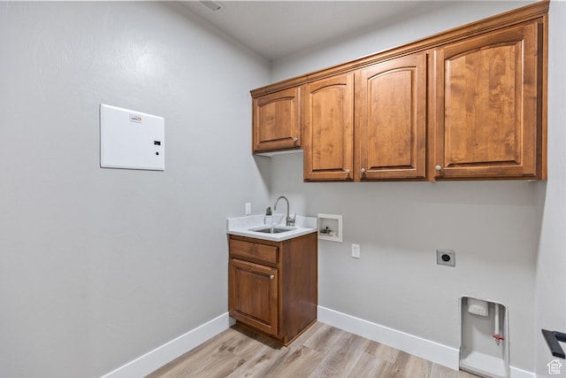 1095 S White Sands Dr, Washington, UT 84780 - laundry area featuring cabinet space, light wood-style flooring, washer hookup, electric dryer hookup, and baseboards
