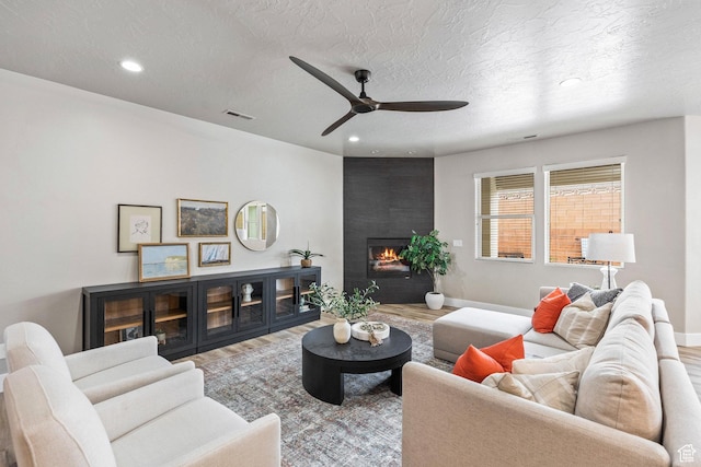 1095 S White Sands Dr, Washington, UT 84780 - living area featuring wood finished floors, a large fireplace, a ceiling fan, recessed lighting, and baseboards