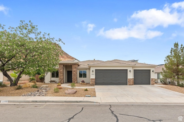 1095 S White Sands Dr, Washington, UT 84780 - view of front of house featuring an attached garage, stucco siding, concrete driveway, and stone siding