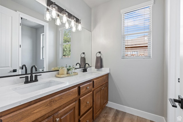 1095 S White Sands Dr, Washington, UT 84780 - bathroom featuring wood finished floors, baseboards, and double vanity