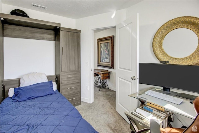 bedroom featuring light carpet, baseboards, and an office area