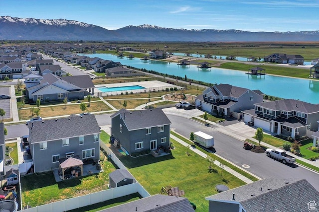 aerial view of residential area featuring a water and mountain view