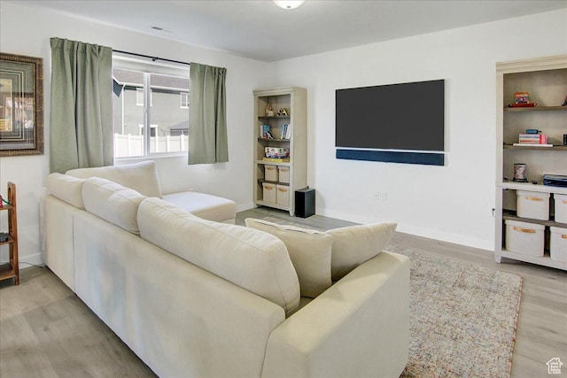 living area with light wood finished floors and baseboards