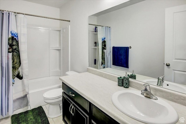 bathroom featuring toilet, vanity, tile patterned floors, and shower / tub combo