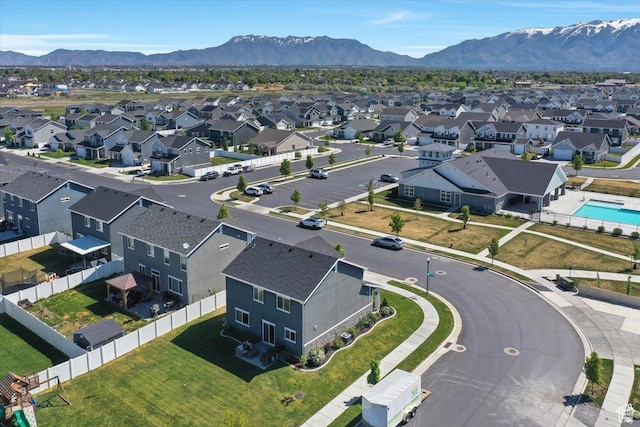 aerial view of residential area with a mountainous background and a pool area