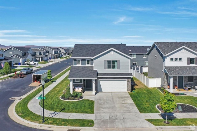 traditional-style home with a residential view, a garage, driveway, and a shingled roof