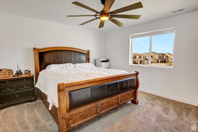 carpeted bedroom with baseboards and ceiling fan