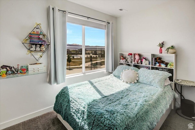 bedroom featuring carpet flooring and baseboards
