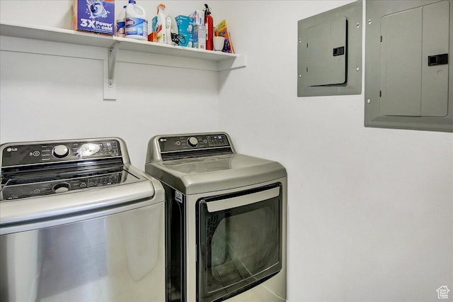washroom featuring electric panel and washing machine and clothes dryer