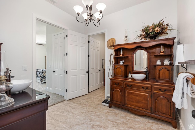 bathroom featuring a chandelier and vanity