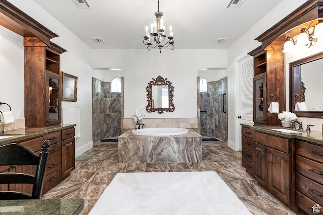 full bathroom with a bath, walk in shower, a chandelier, and marble finish flooring