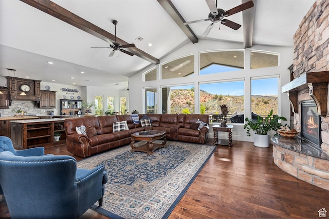 living area featuring ceiling fan, beamed ceiling, a fireplace, recessed lighting, and dark wood finished floors