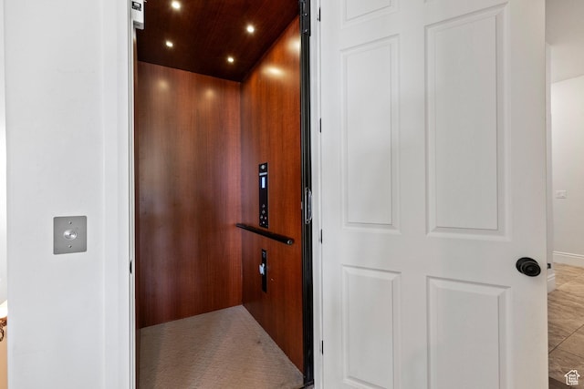 elevator featuring recessed lighting and wooden ceiling