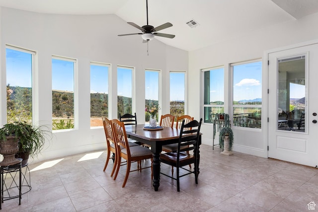 sunroom / solarium featuring vaulted ceiling, tile patterned flooring, and baseboards