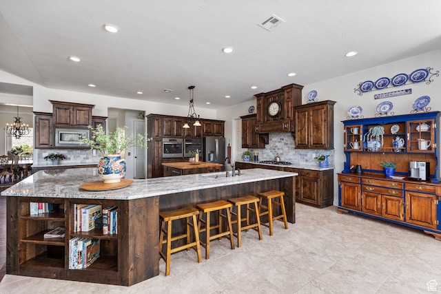 kitchen with open shelves, appliances with stainless steel finishes, a large island, a sink, and tasteful backsplash