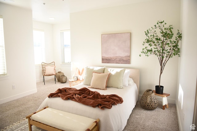 carpeted bedroom featuring baseboards