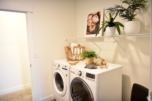laundry area featuring washing machine and dryer, carpet flooring, and baseboards