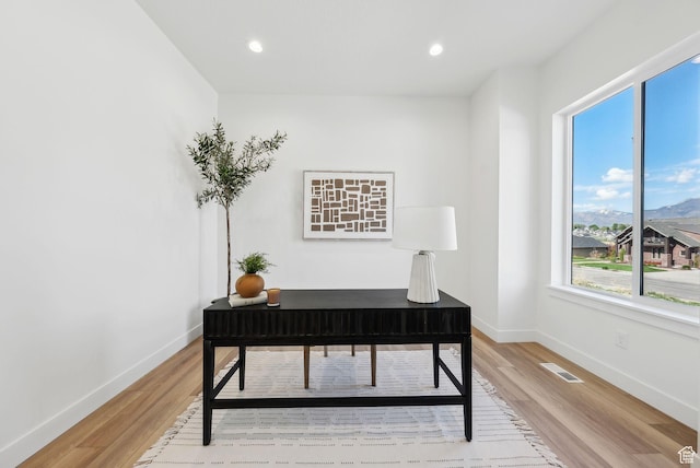 office space with light wood-type flooring, baseboards, and recessed lighting