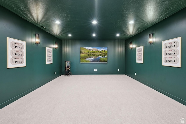 cinema room with recessed lighting, carpet flooring, a textured ceiling, and baseboards