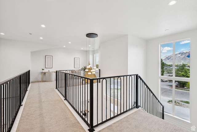 hall featuring recessed lighting, an upstairs landing, light carpet, and baseboards