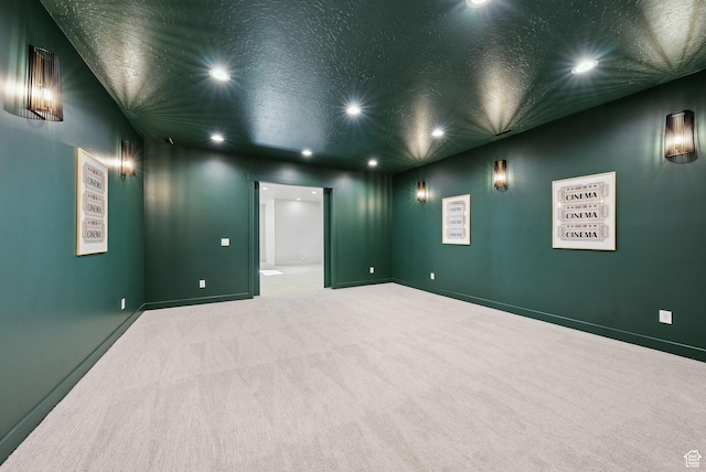 unfurnished room with recessed lighting, carpet floors, baseboards, and a textured ceiling