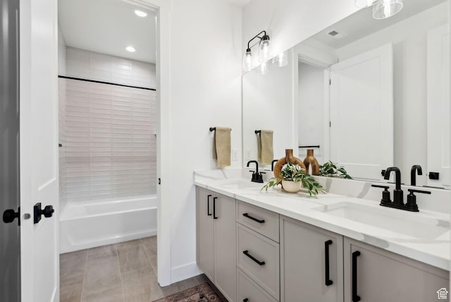 full bathroom featuring double vanity, recessed lighting, and washtub / shower combination