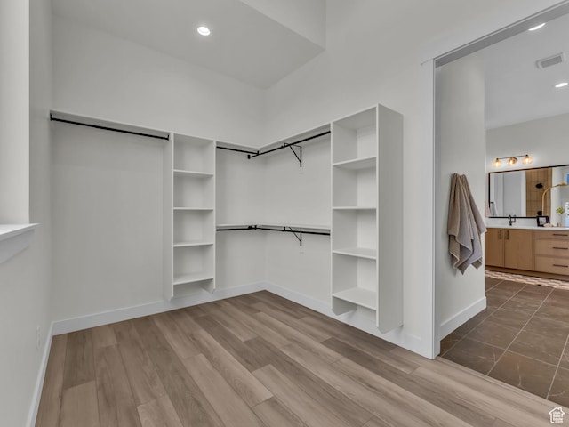 walk in closet featuring wood finished floors