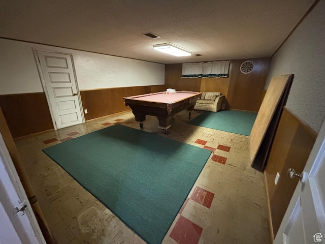 recreation room featuring wooden walls, billiards table, tile patterned floors, and a wainscoted wall