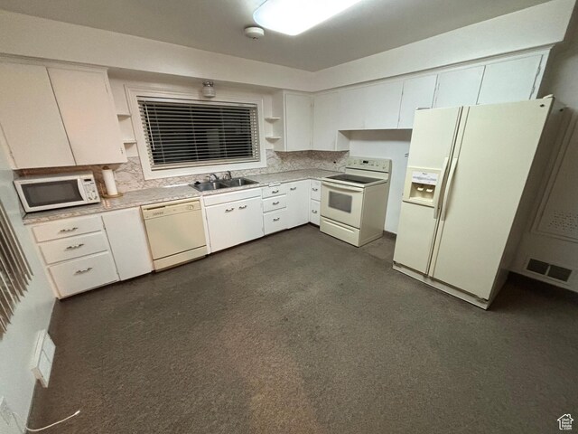 kitchen featuring white appliances, open shelves, a sink, and light countertops