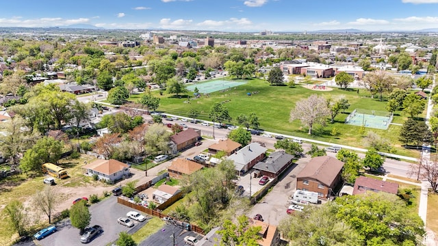 aerial view of property and surrounding area featuring nearby suburban area
