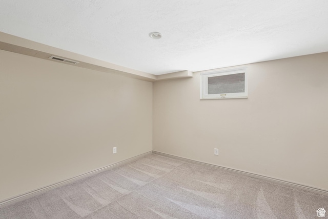 empty room with light carpet and baseboards