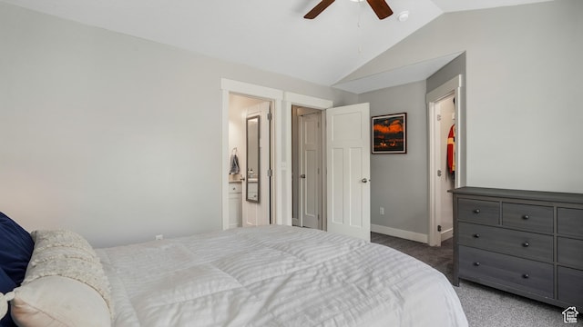 carpeted bedroom with lofted ceiling, baseboards, ensuite bathroom, and a ceiling fan