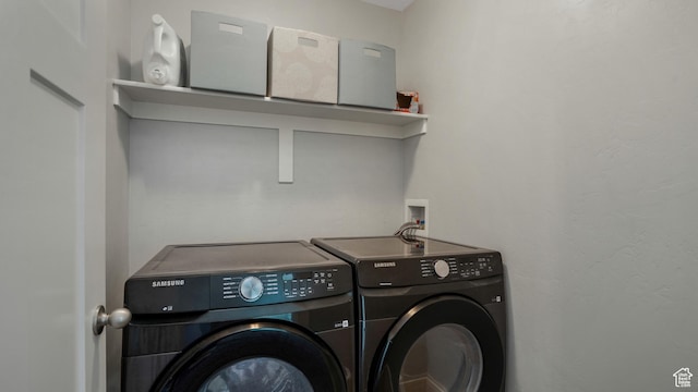 clothes washing area with washer and dryer
