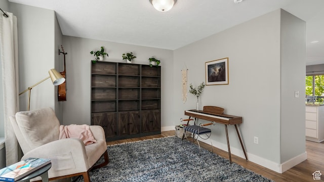 living area with wood finished floors and baseboards