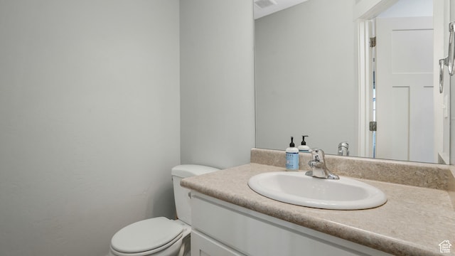 bathroom with toilet and vanity