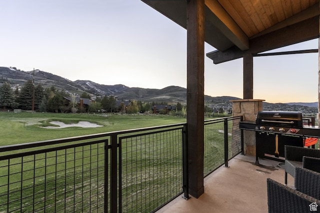 balcony with a mountain view and area for grilling