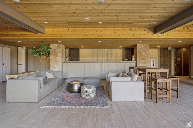 living room featuring wood ceiling, wooden walls, beamed ceiling, and wood tiled floors