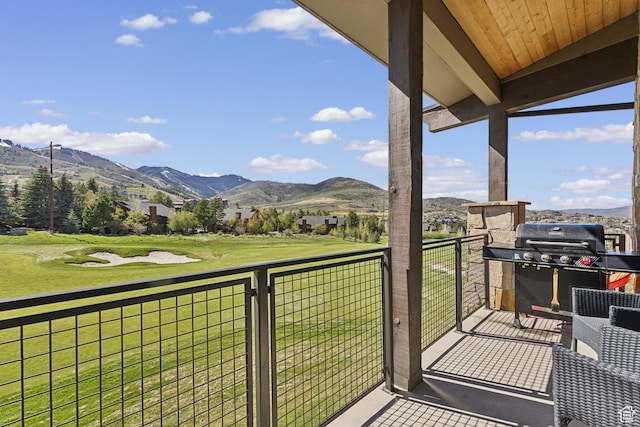 balcony featuring a mountain view and a grill