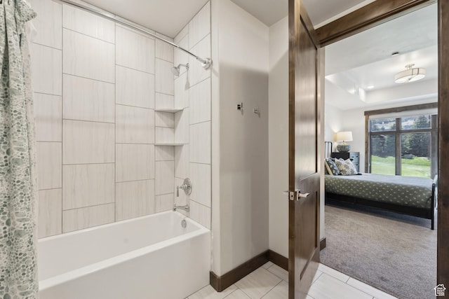 bathroom featuring baseboards, ensuite bathroom, shower / tub combo with curtain, tile patterned flooring, and a tray ceiling